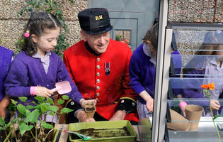 Young children gardening in a greenhouse