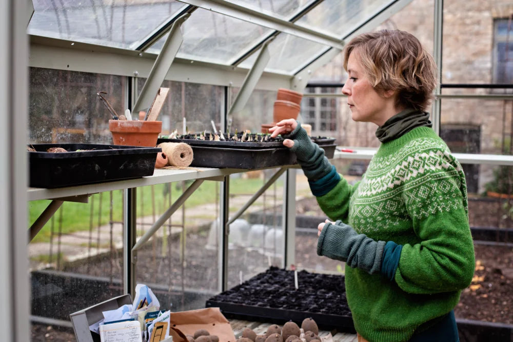 Kathy using inspecting her seedlings