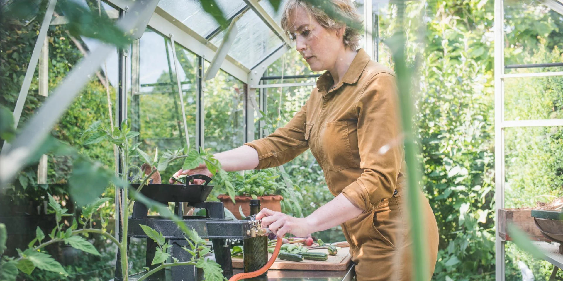 Kathy getting ready to cook in her greenhouse