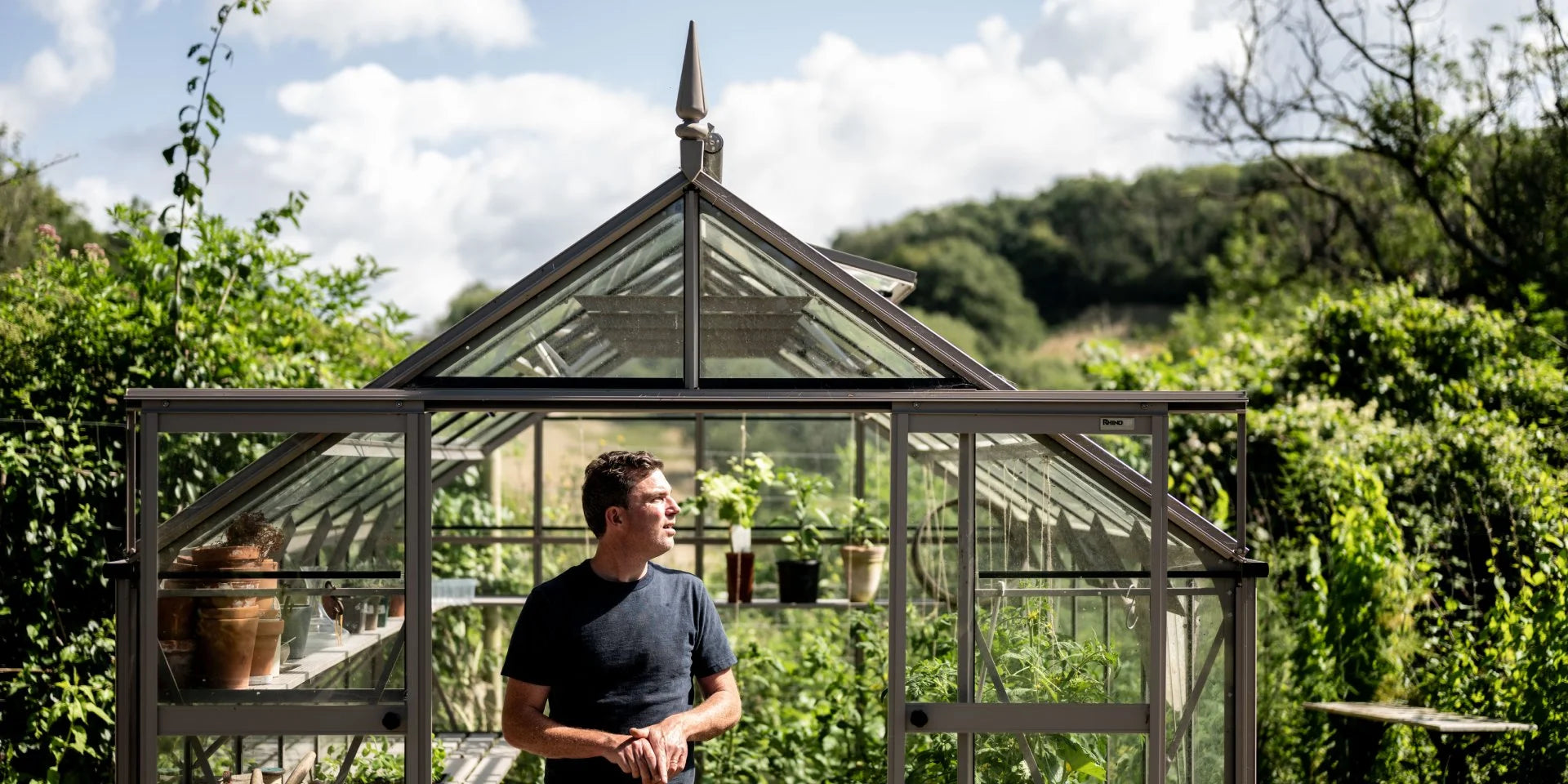 Gill inside his Rhino greenhouse